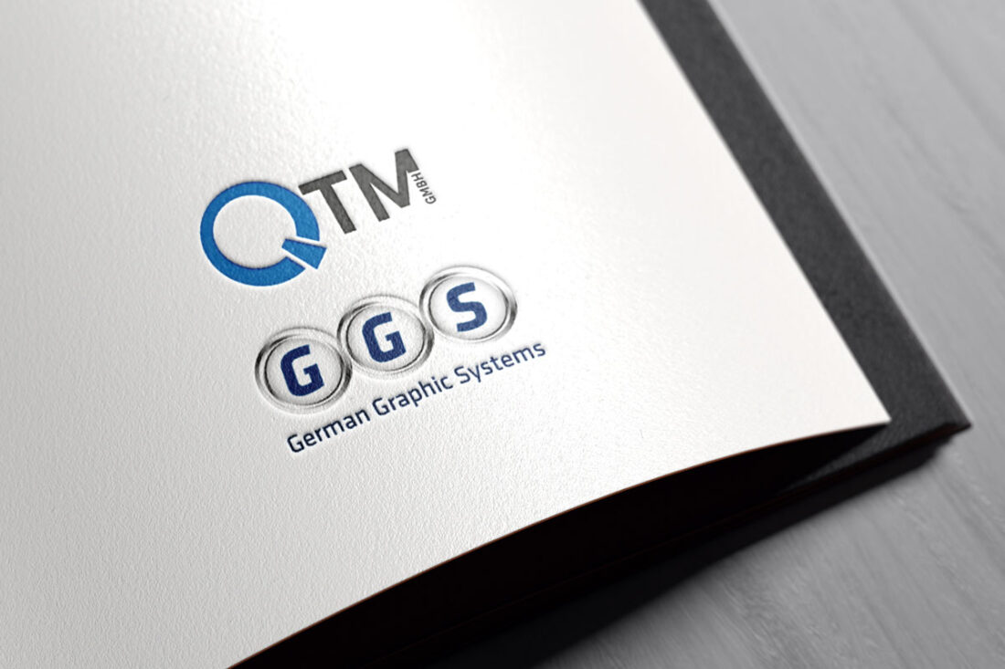 QTM und GGS Logo auf einer Papierseite
